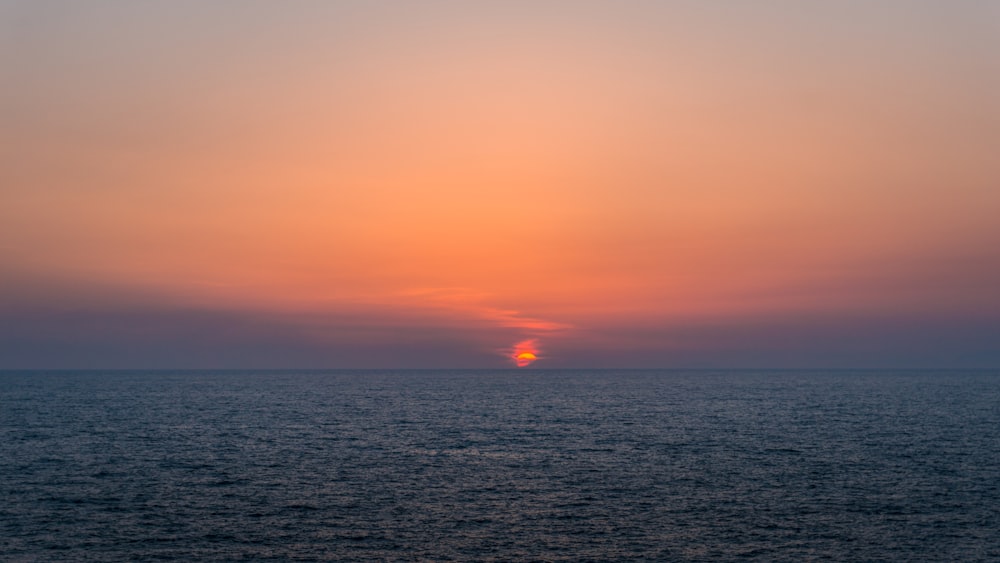 body of water during sunset