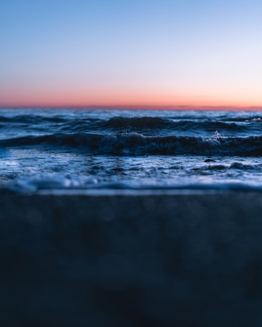 ocean waves crashing on shore during sunset in Saint John Canada