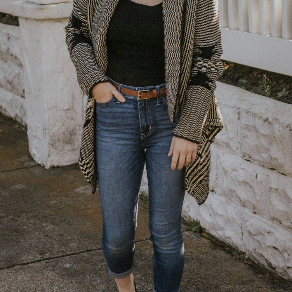 woman in black and white striped long sleeve shirt and blue denim jeans