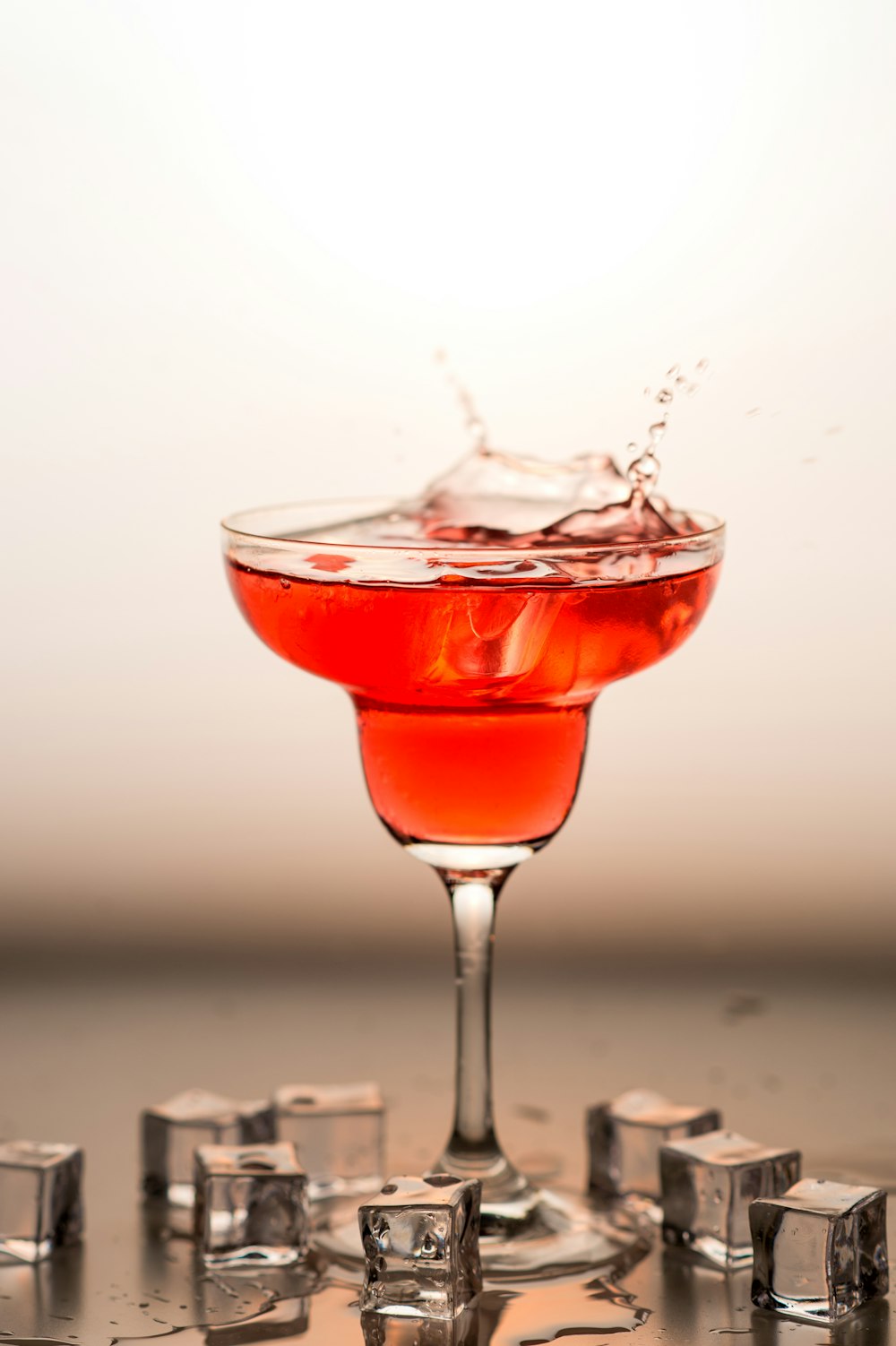 red liquid in clear wine glass