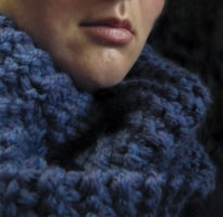 Close-up of a man wearing a thick knitted scarf outdoors in winter