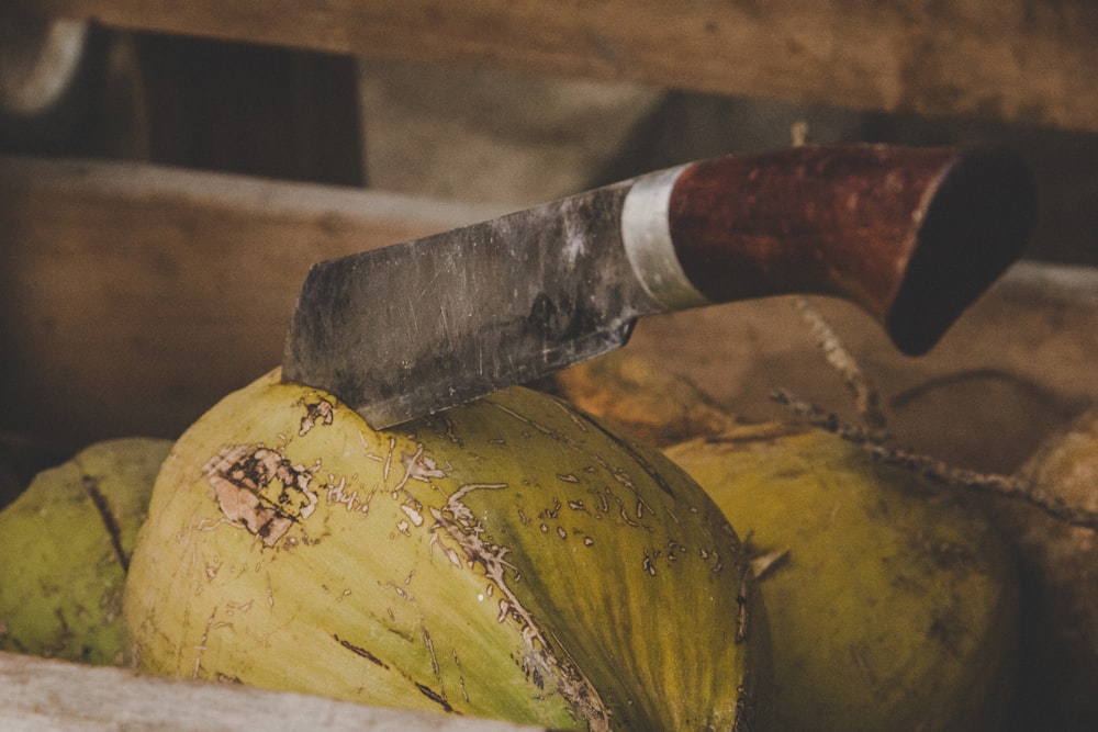 brown and silver knife on yellow and brown wooden surface