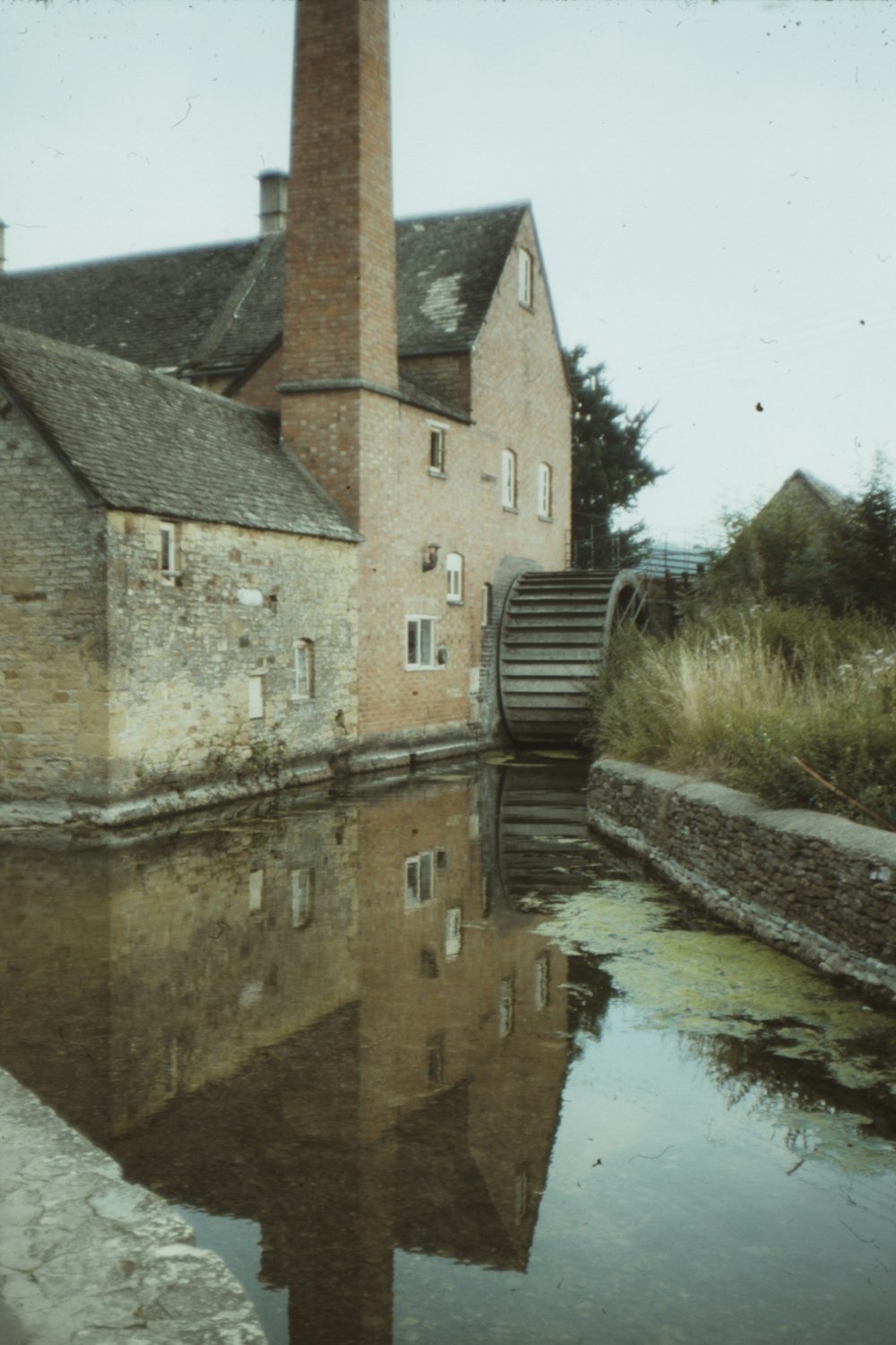 brown brick building beside river