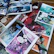 Close-up of colorful comic book pages spread out on a wooden table.