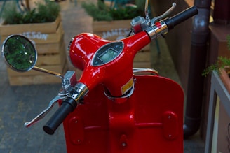 Close-up of a lightweight electric scooter's handlebar and display panel in bright daylight.