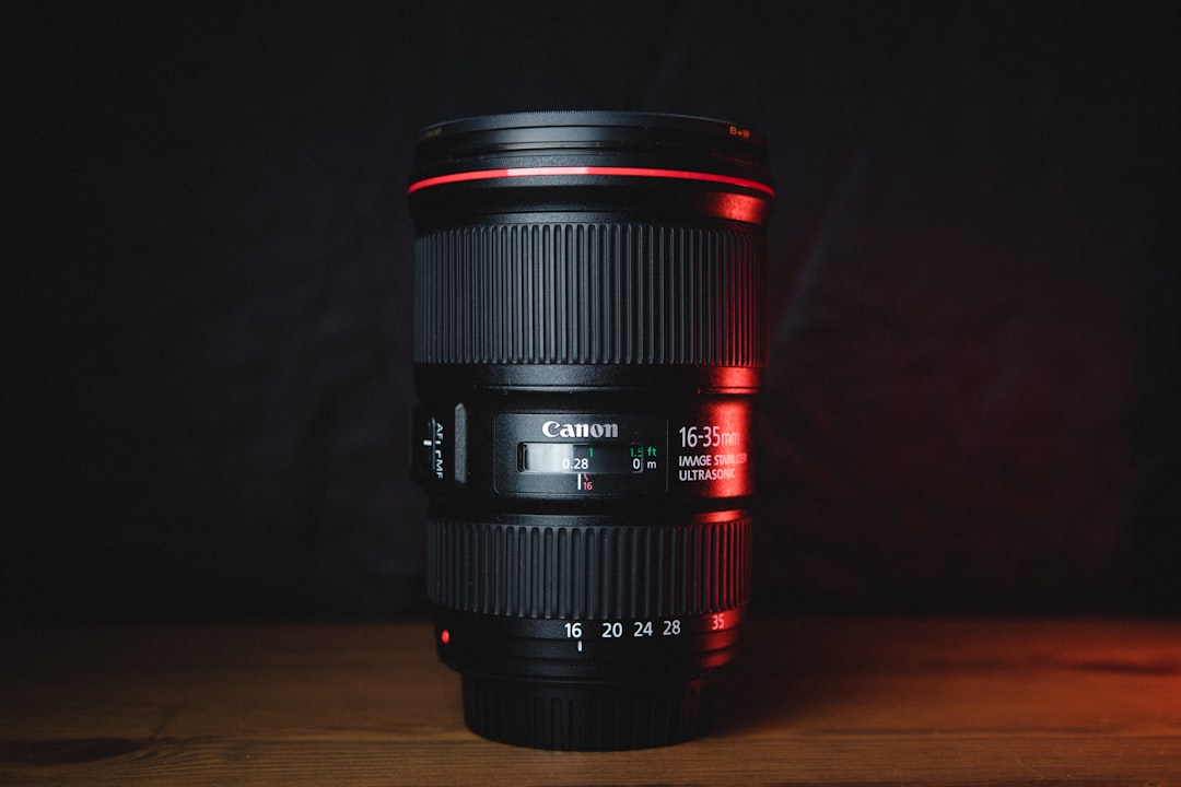 black camera lens on brown wooden table