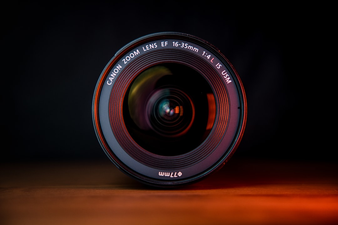 black camera lens on brown wooden table,