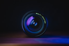 black camera lens on blue surface