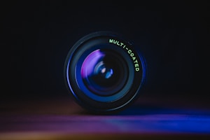 black camera lens on blue surface