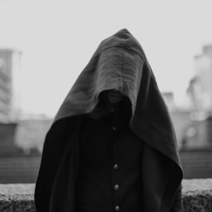 grayscale photo of person covered with blanket