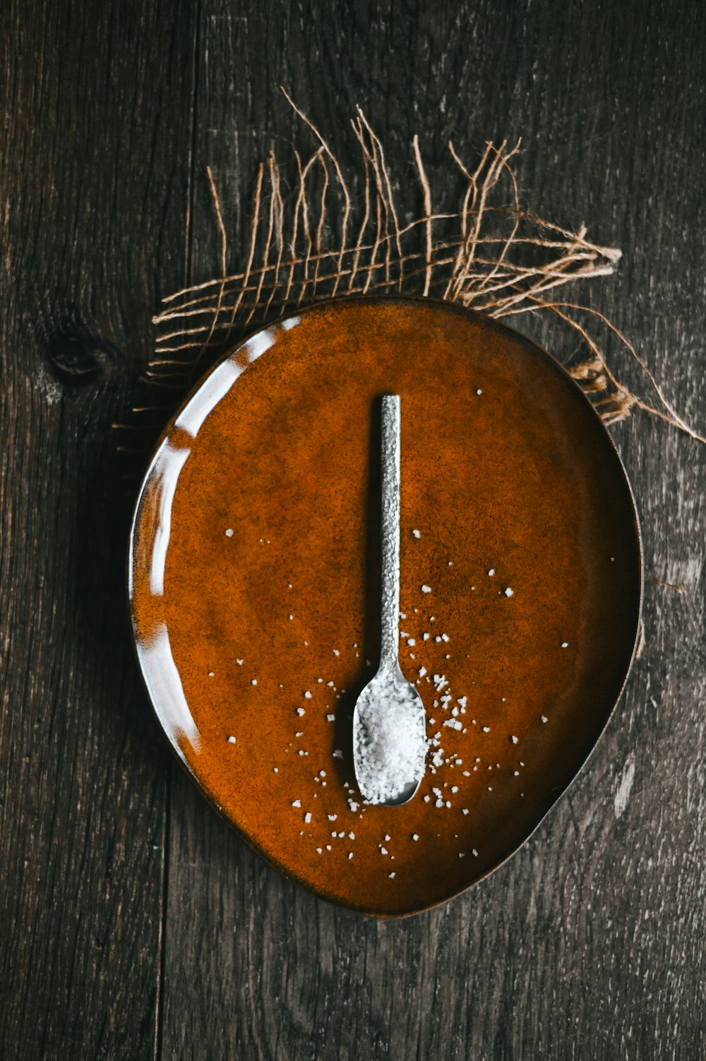 brown wooden round plate with silver fork