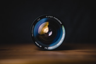 black camera lens on brown wooden table