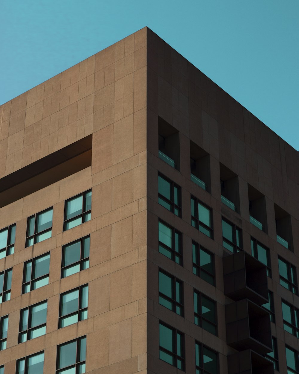 brown concrete building under blue sky during daytime