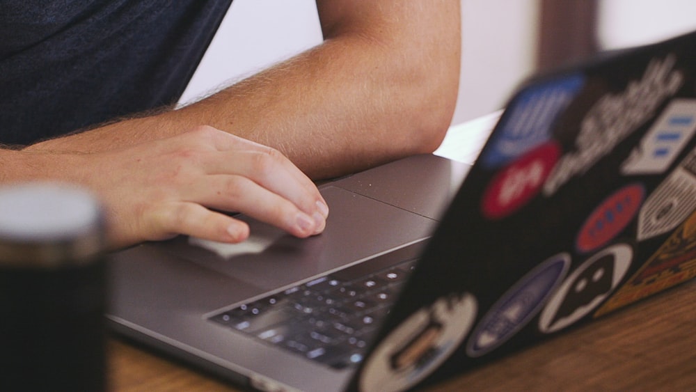 person using black laptop computer