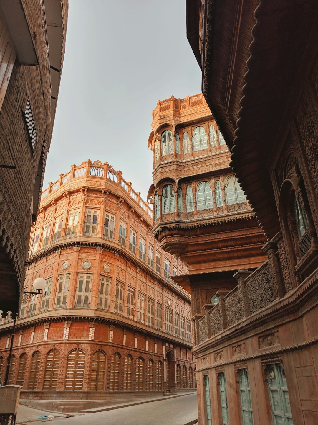 brown concrete building during daytime in Rampuria Havelis India