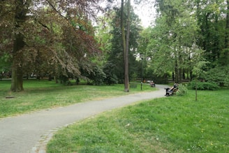 A serene park with lush greenery and walking paths, inviting residents to enjoy outdoor activities.