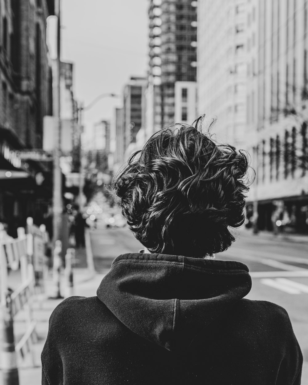 grayscale photo of man in hoodie