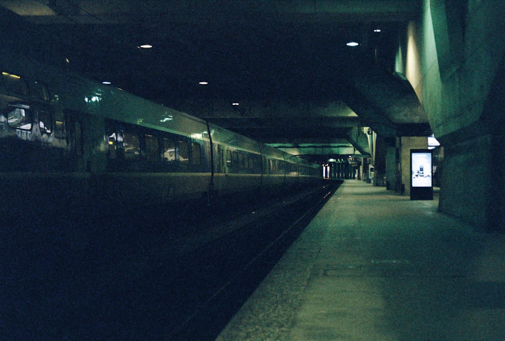 train station with lights turned on during night time