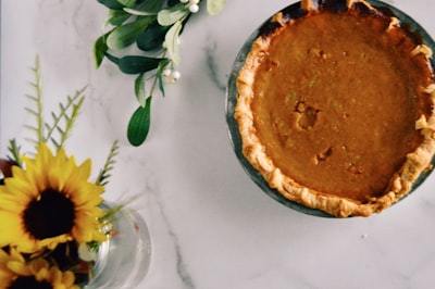 brown pie on black and white ceramic plate pumpkin pie zoom background