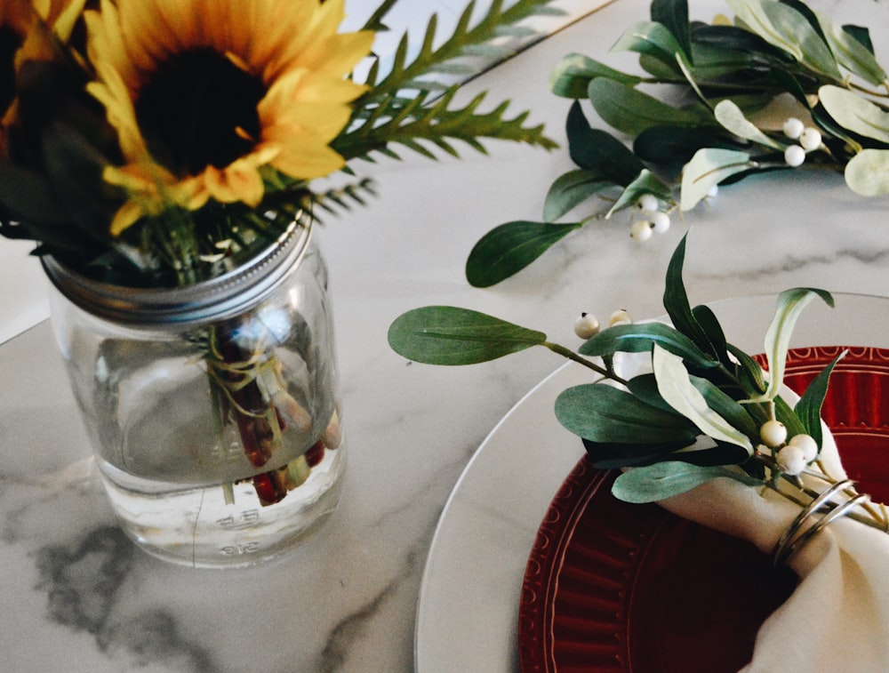 yellow sunflower in clear glass vase