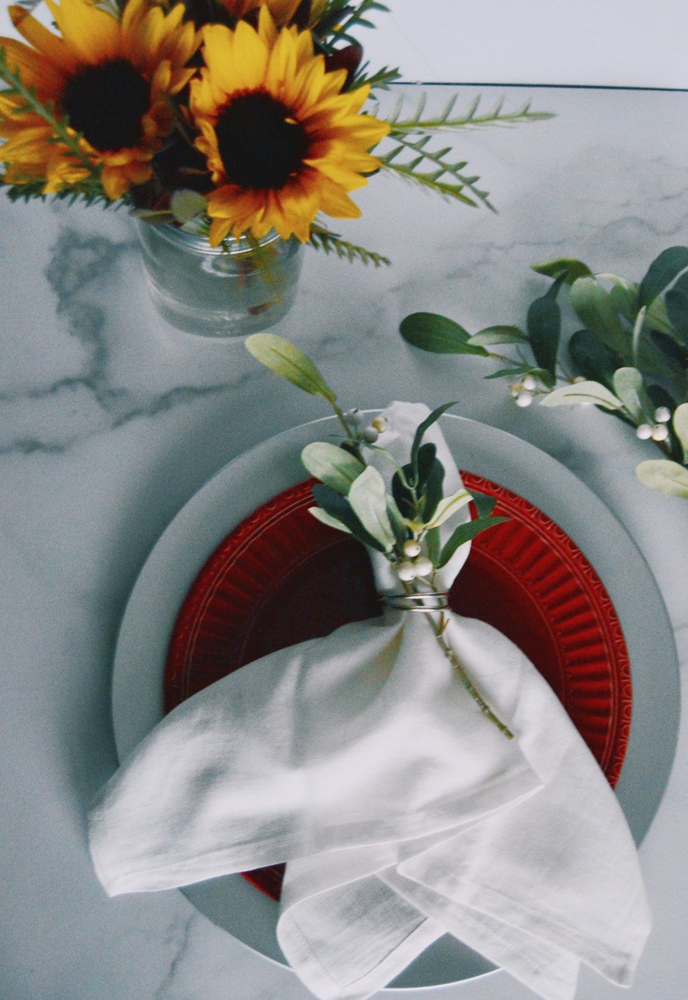 yellow and red flowers in clear glass vase