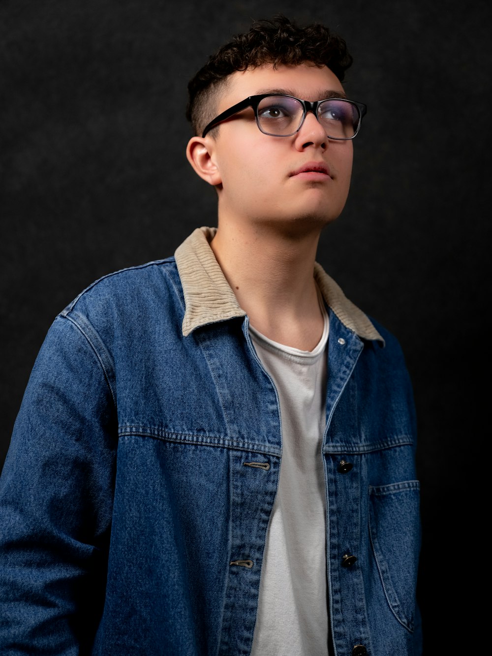 man in blue denim button up jacket wearing black sunglasses