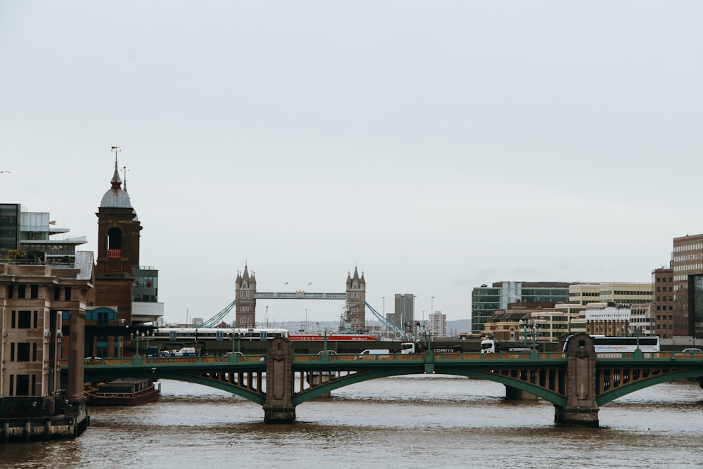 green bridge over river during daytime