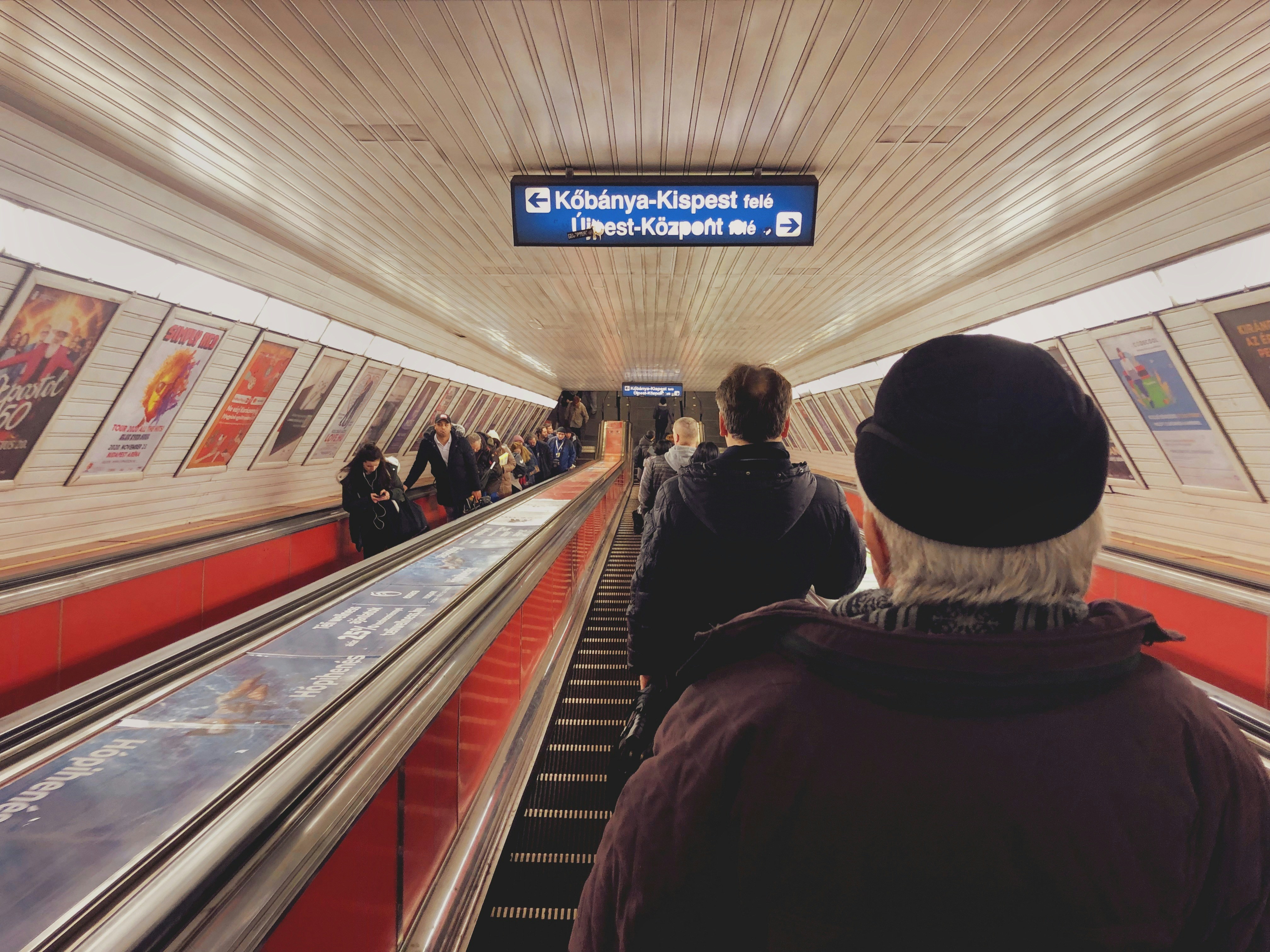 people sitting on escalator inside building, On the way to The Other WorkSpace. - Budapest Metro