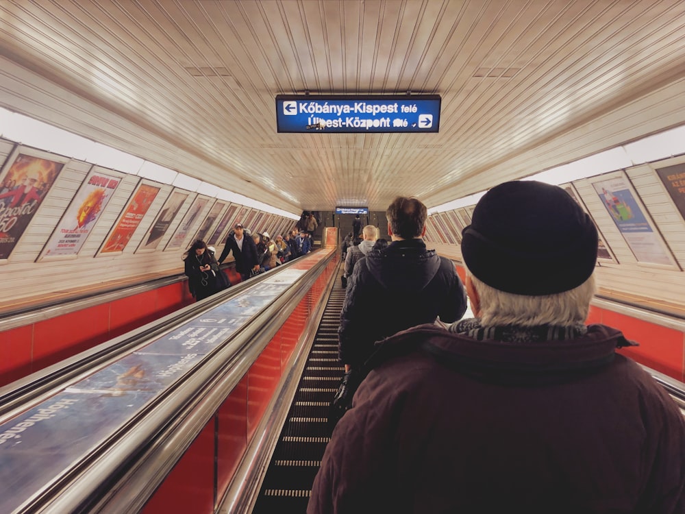 people sitting on escalator inside building