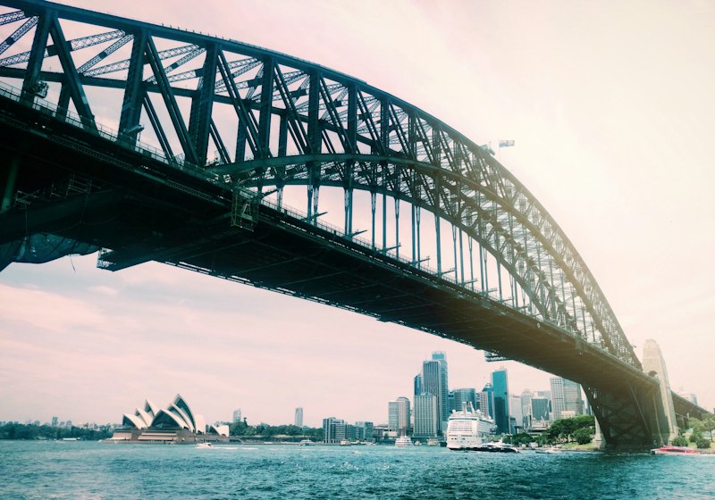 gray metal bridge over body of water during daytime
