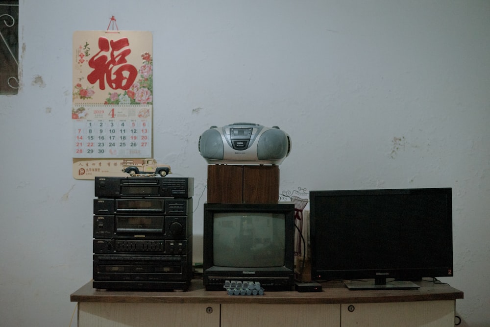 black flat screen tv on brown wooden tv rack