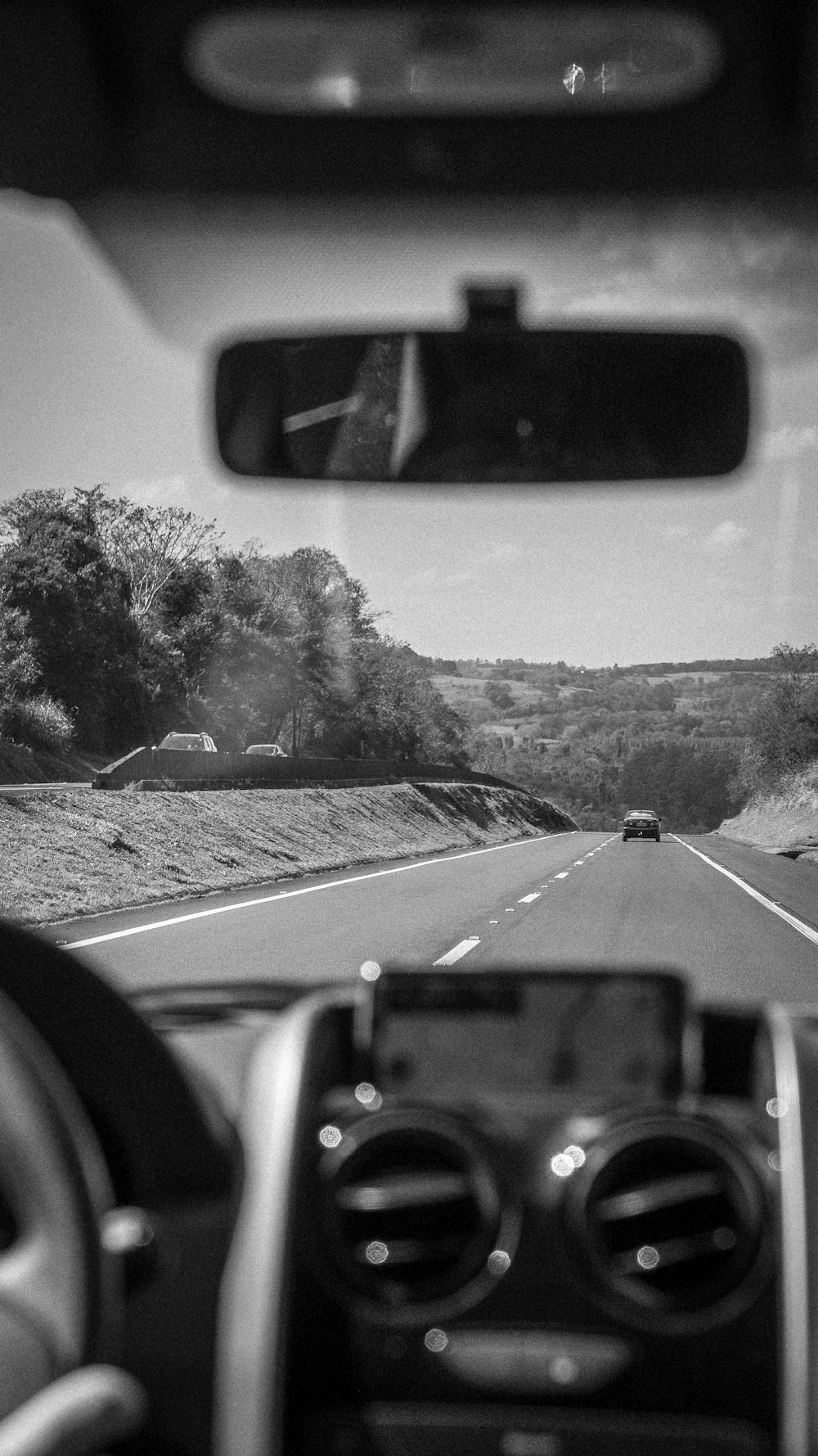 grayscale photo of car on road