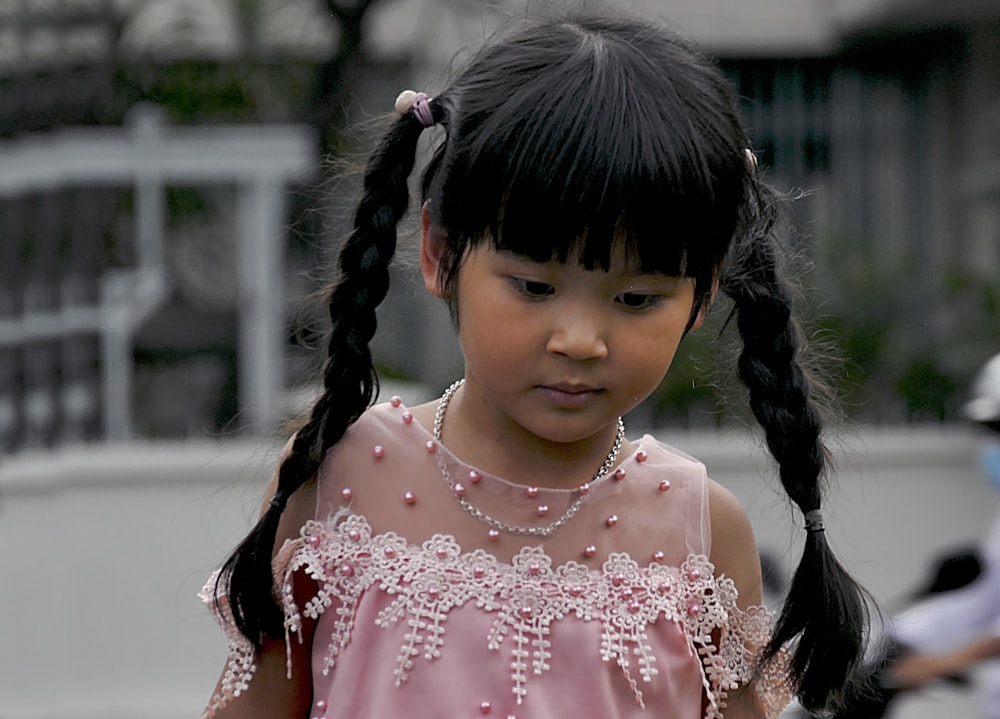 girl in pink and white floral dress