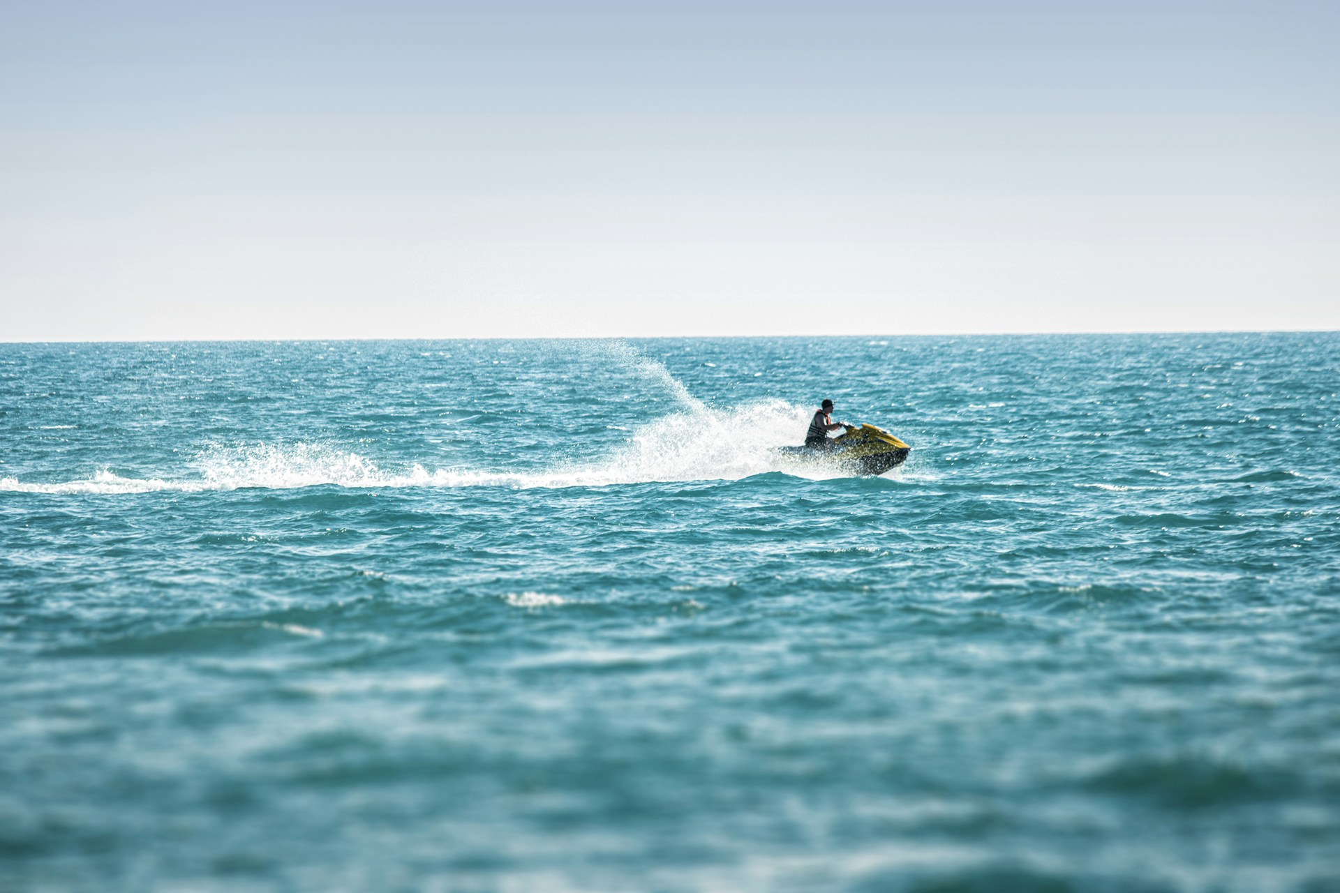 man surfing on sea waves during daytime
