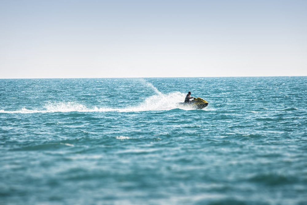 man surfing on sea waves during daytime