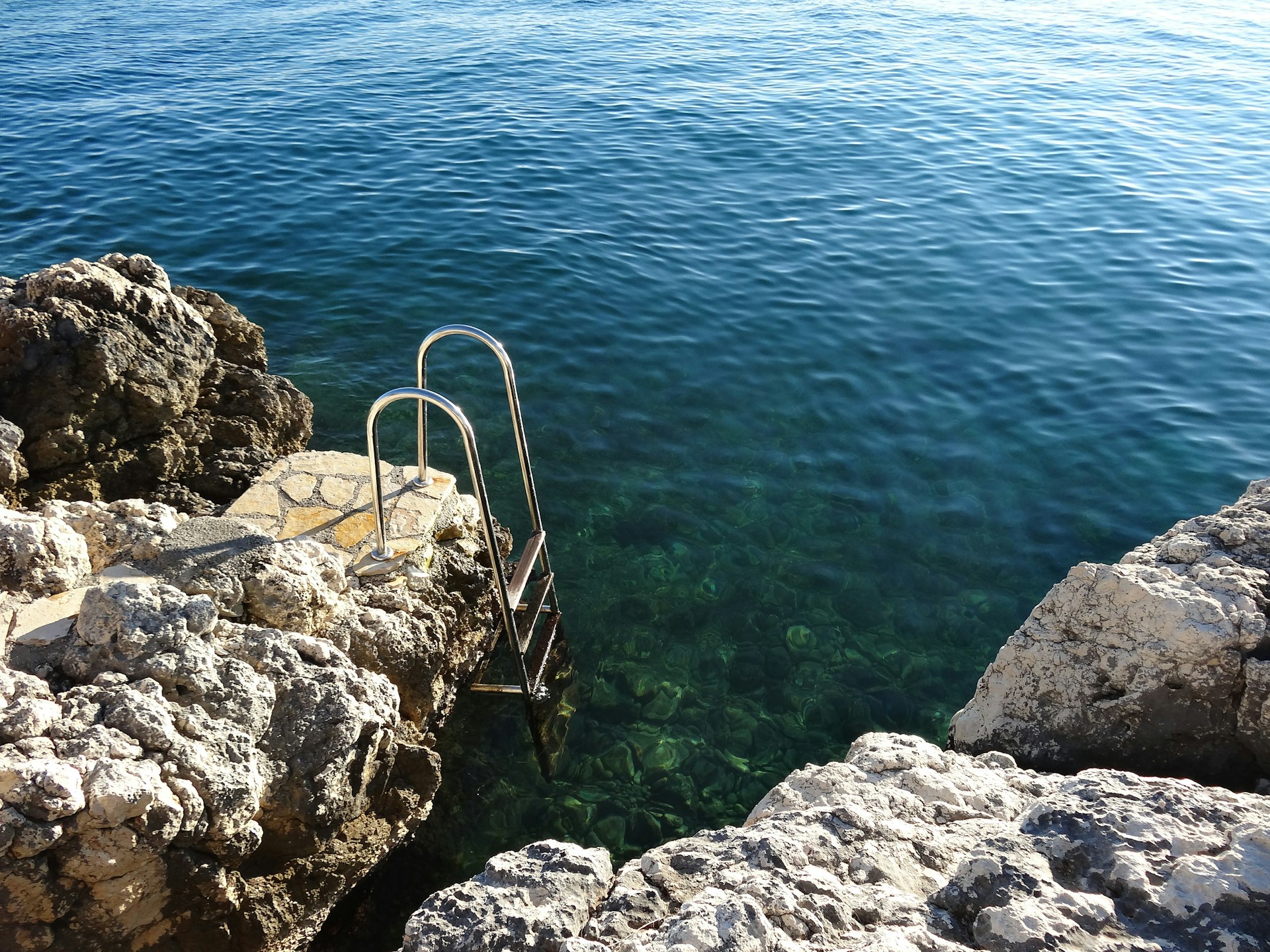 gray and brown rocks beside blue sea during daytime