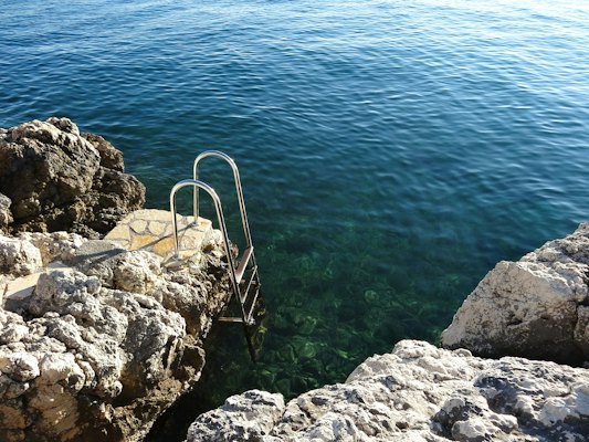 A ladder down into the sea from the rocks — Zadar, Croatia