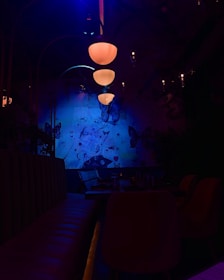 Cool blue party room decorated with dragonfly themes and soft lighting.