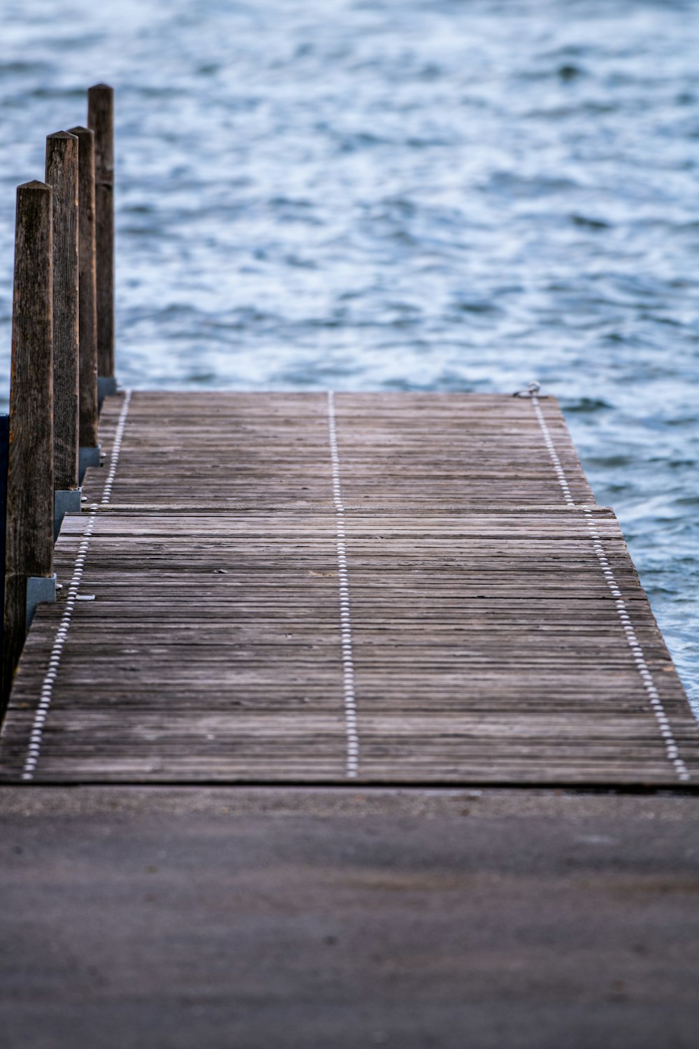 brown wooden dock on blue sea during daytime