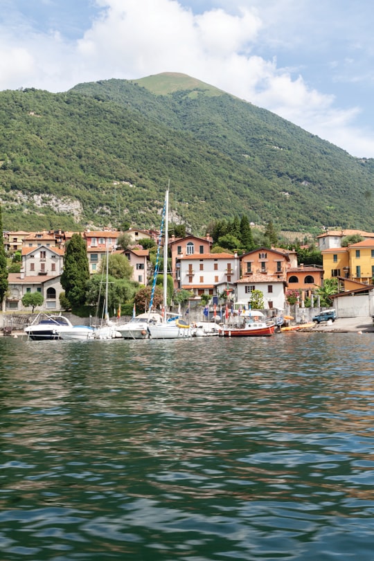 white boat on body of water near green mountain during daytime in Lake Como Italy