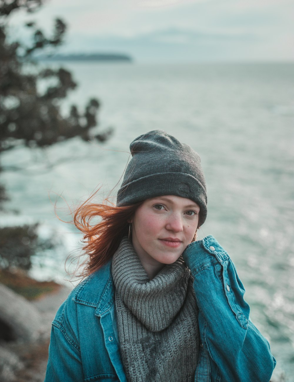 woman in blue denim jacket and gray hat