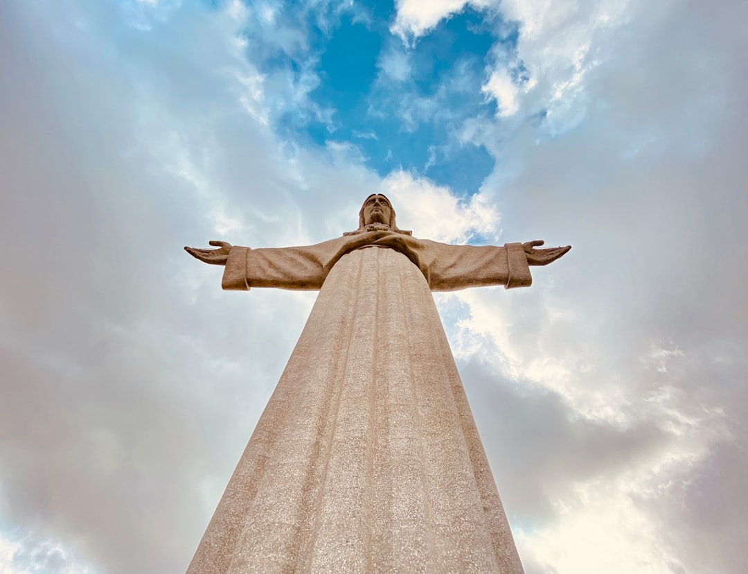 low angle photography of jesus christ statue under blue sky during daytime