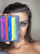 woman holding blue and white abstract painting