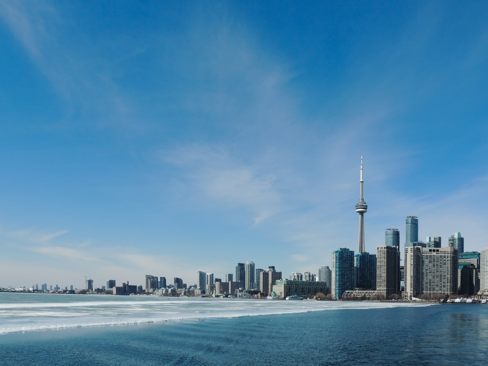 city skyline across body of water during daytime