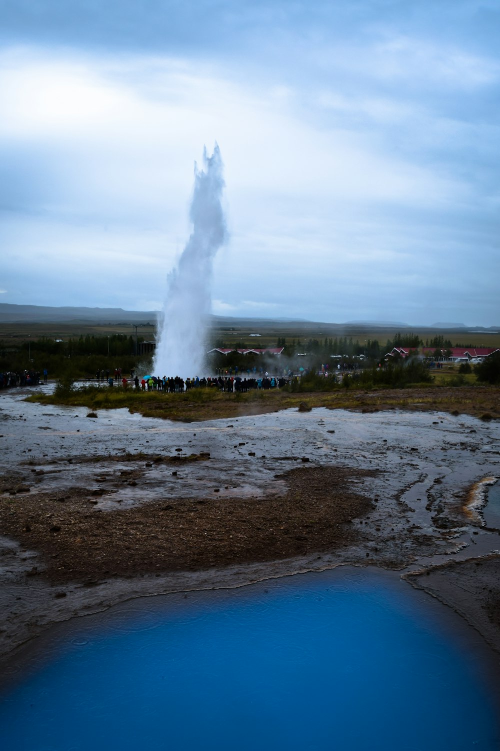 water fountain on brown sand under blue sky during daytime