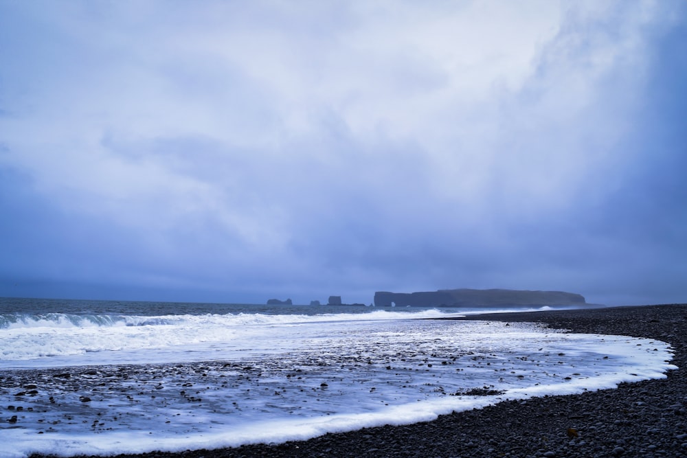 ocean waves crashing on shore during daytime