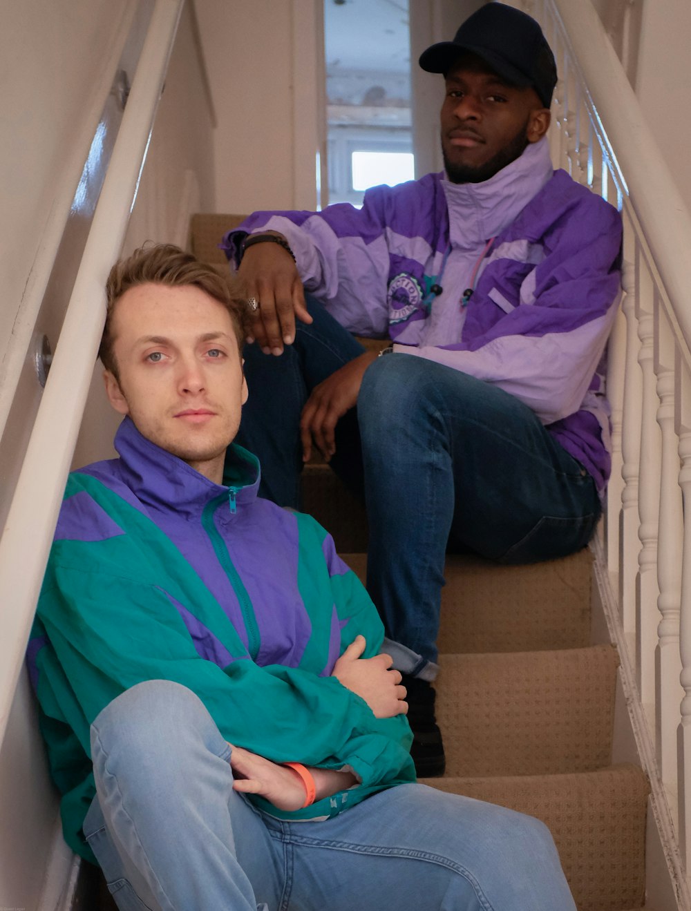 man in blue dress shirt sitting beside man in blue dress shirt