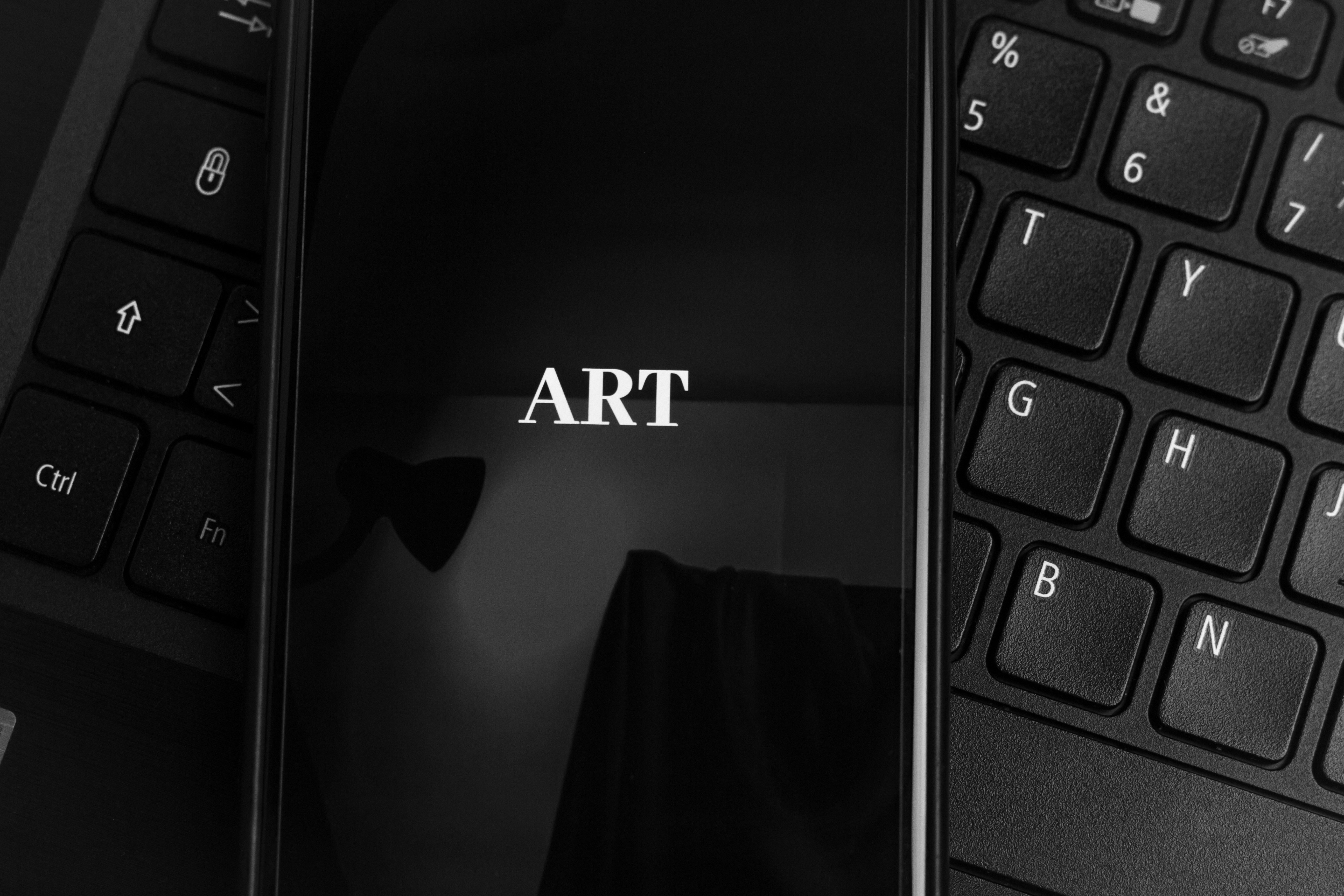 black laptop computer turned on with black textile