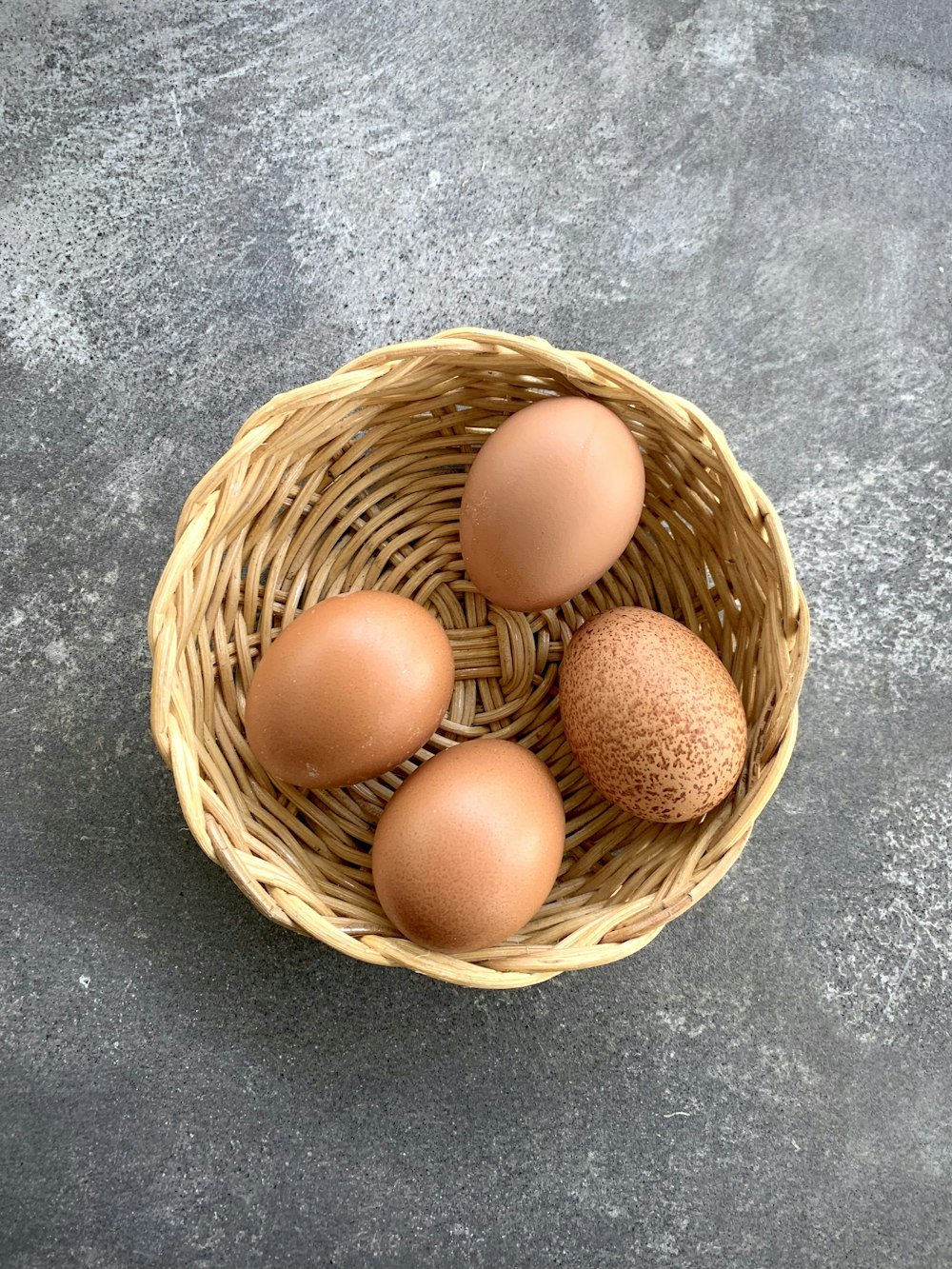 茶色の編まれたバスケットの茶色の卵
