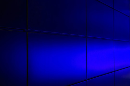 Grid display of smart home devices with dark slate backgrounds and bright blue action buttons.